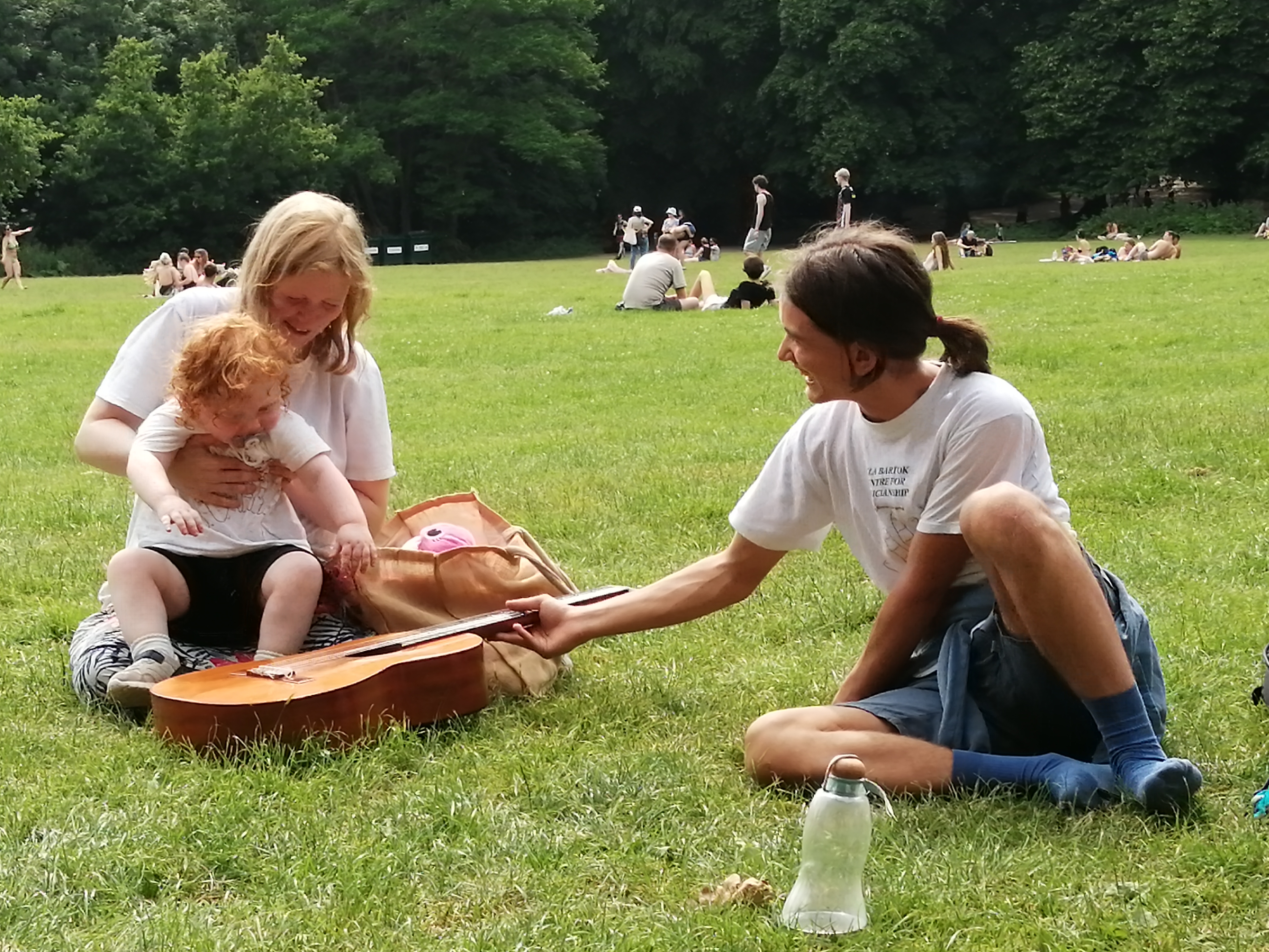 Warm-hearted Boyan offers his guitar to Iris.