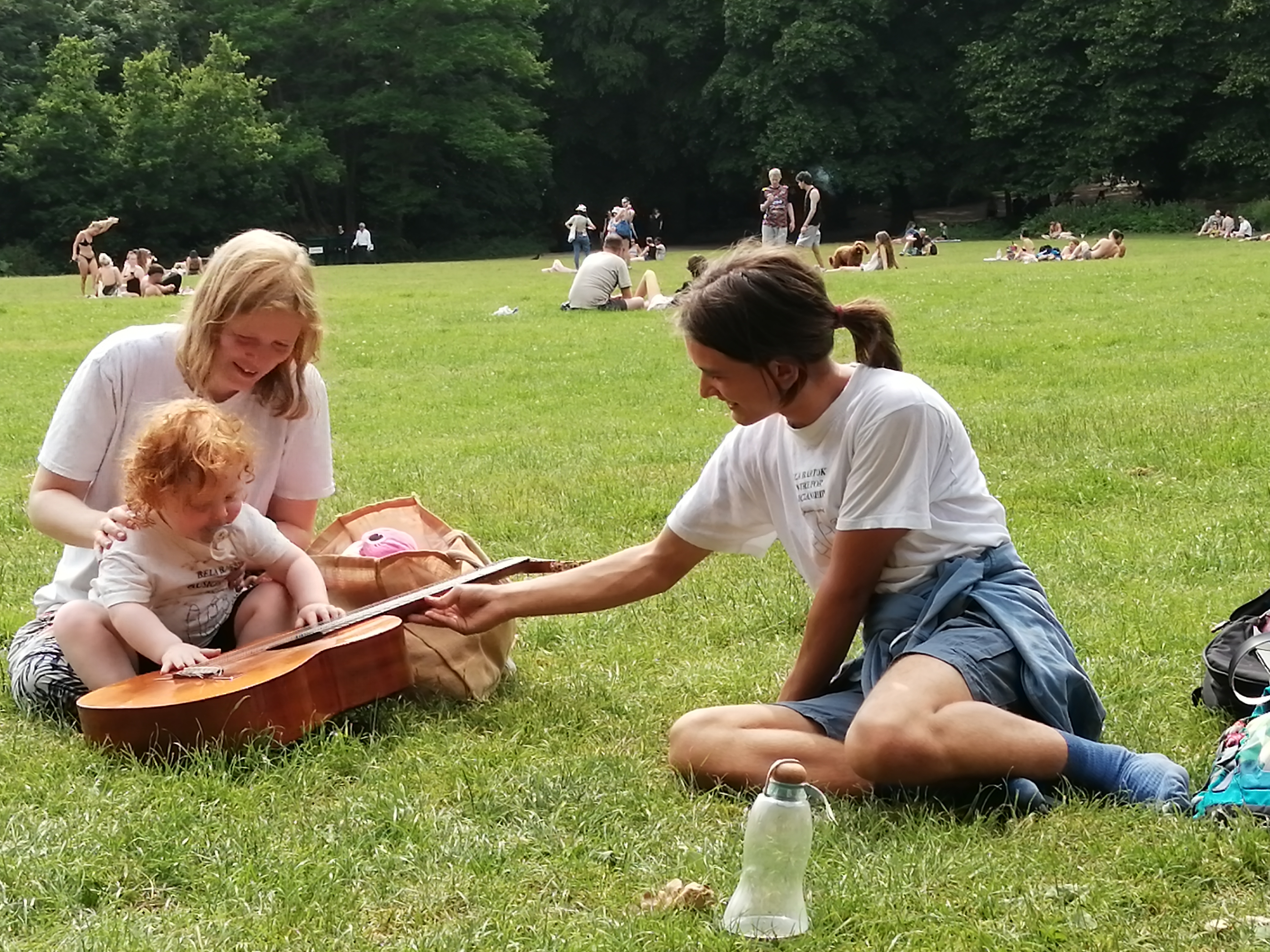 Bravely but gently Iris puts both hands on the guitar.