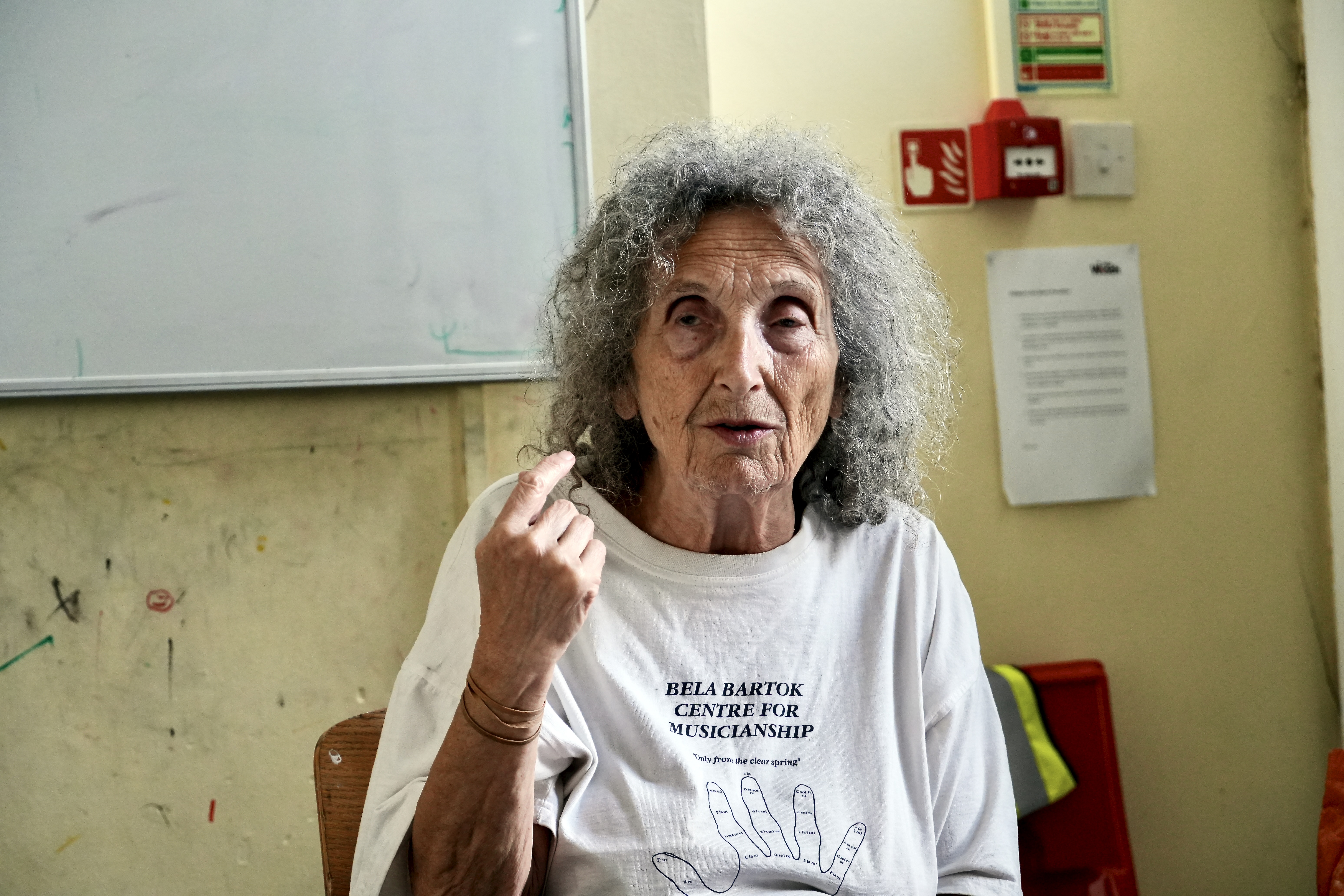 A photograph of Agnes Kory talking in a room with a whiteboard